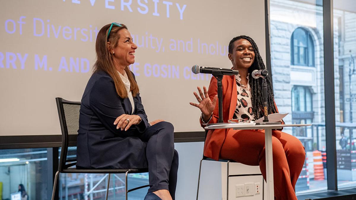 Dr. Stephanie Akunvabey speaking on stage at a conference.
